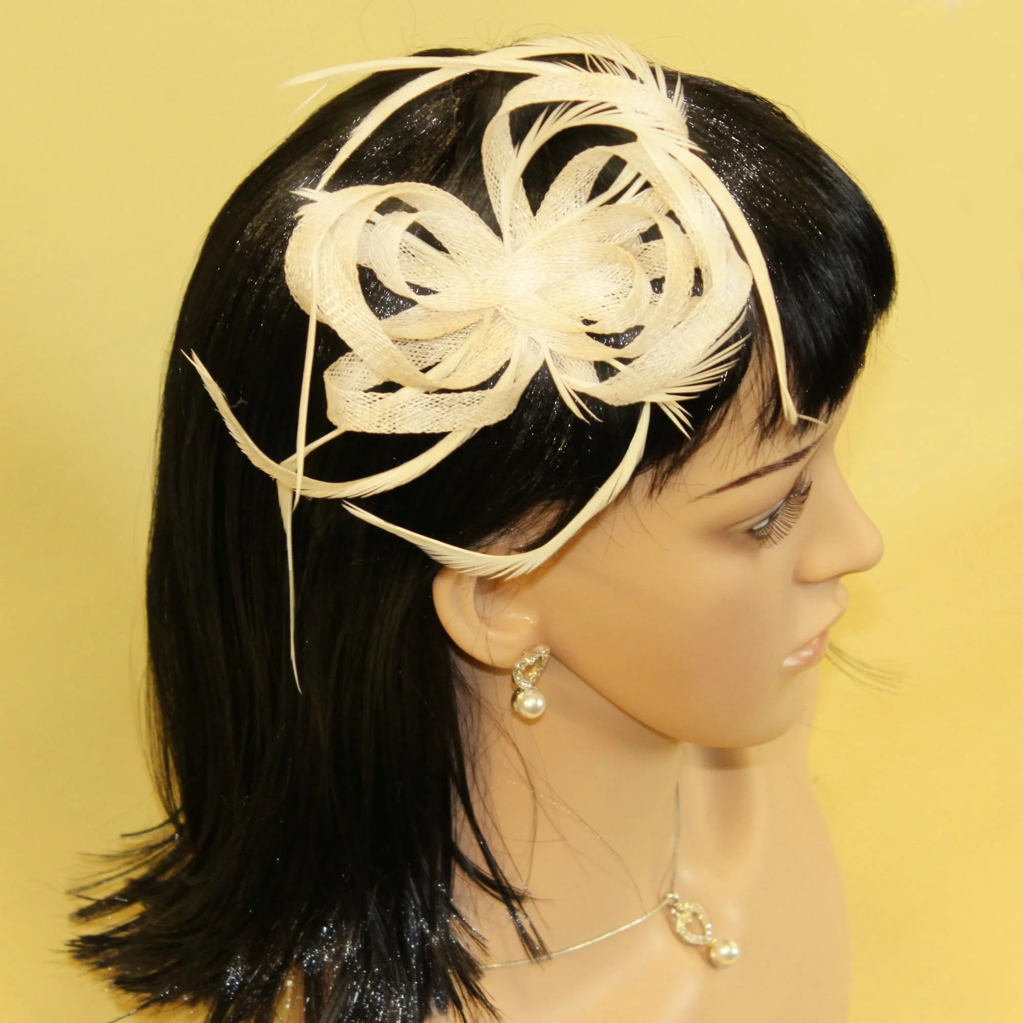 Cream fascinator with hessian loops and feather tendrils (beak and clip)